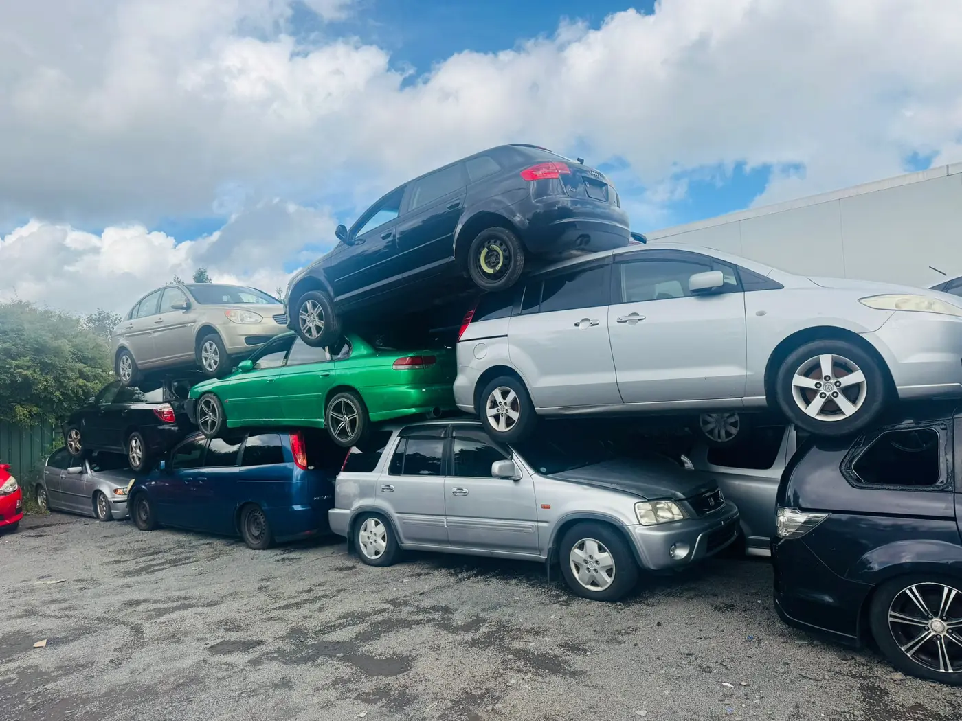 End-of-life cars stacked at the yard ready for depollution and recycling