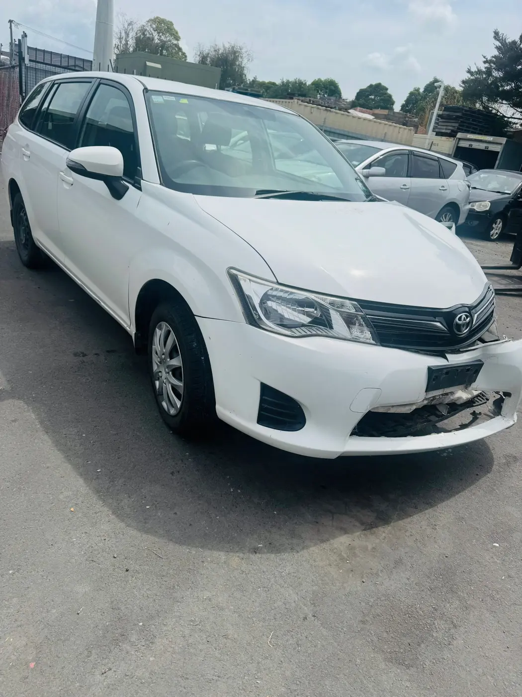 White Toyota Corolla wagon awaiting scrap